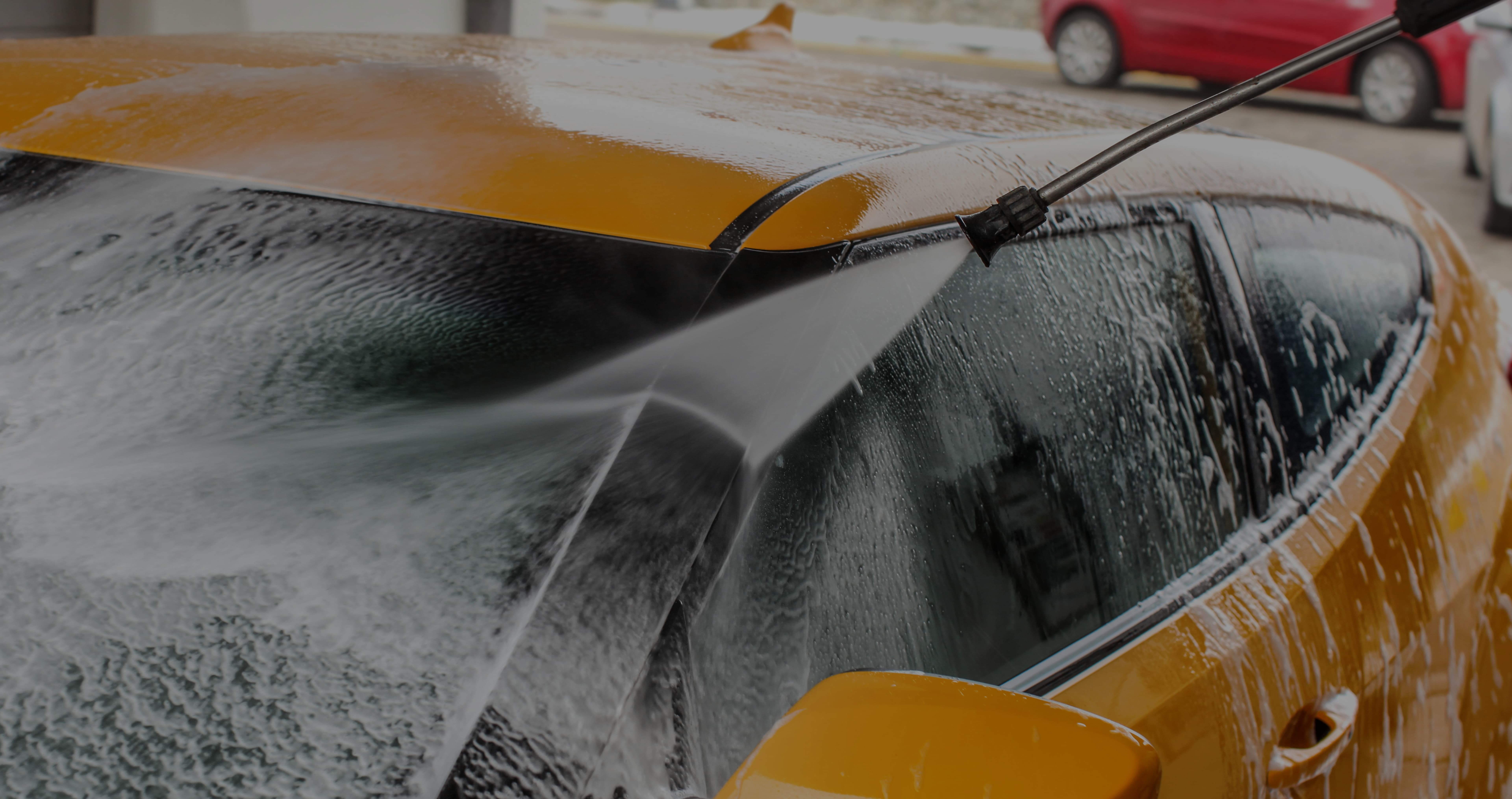 Yellow car getting washed